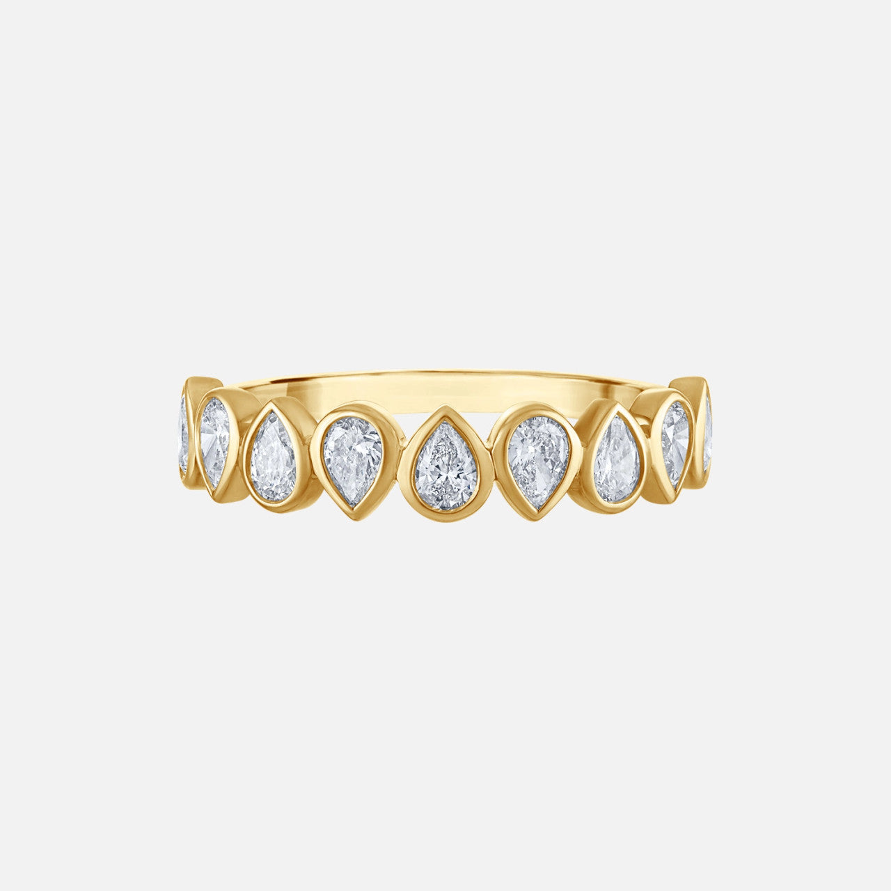 a gold ring with bezeled pear-shaped diamonds pointing in alternating directions