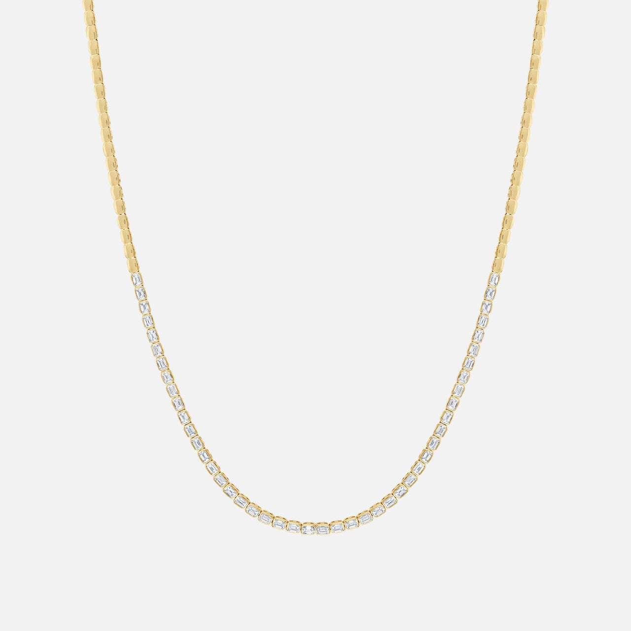 A gold tennis necklace with diamonds halfway around the chain