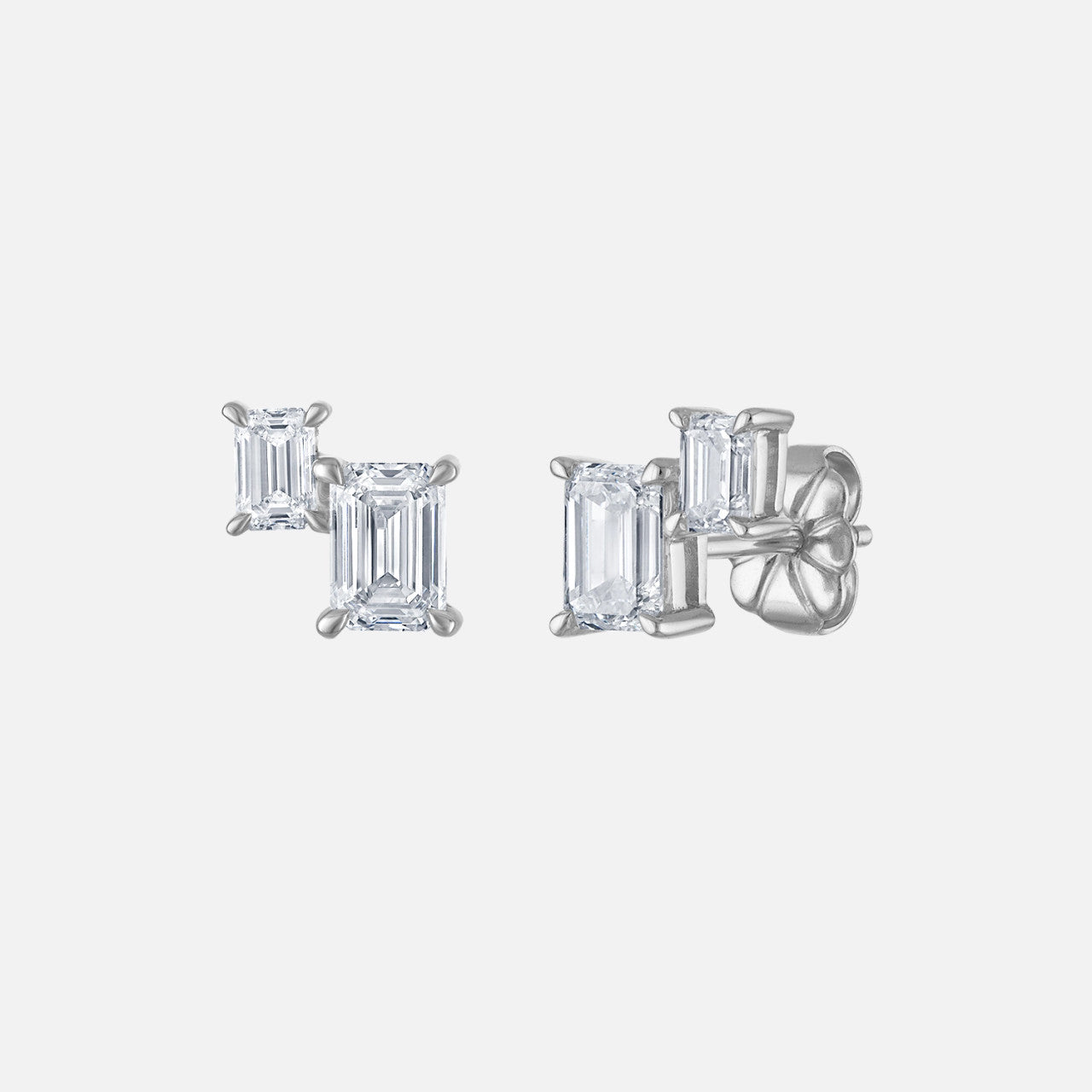 Each stud in this pair of earrings features two emerald-shaped natural diamonds.