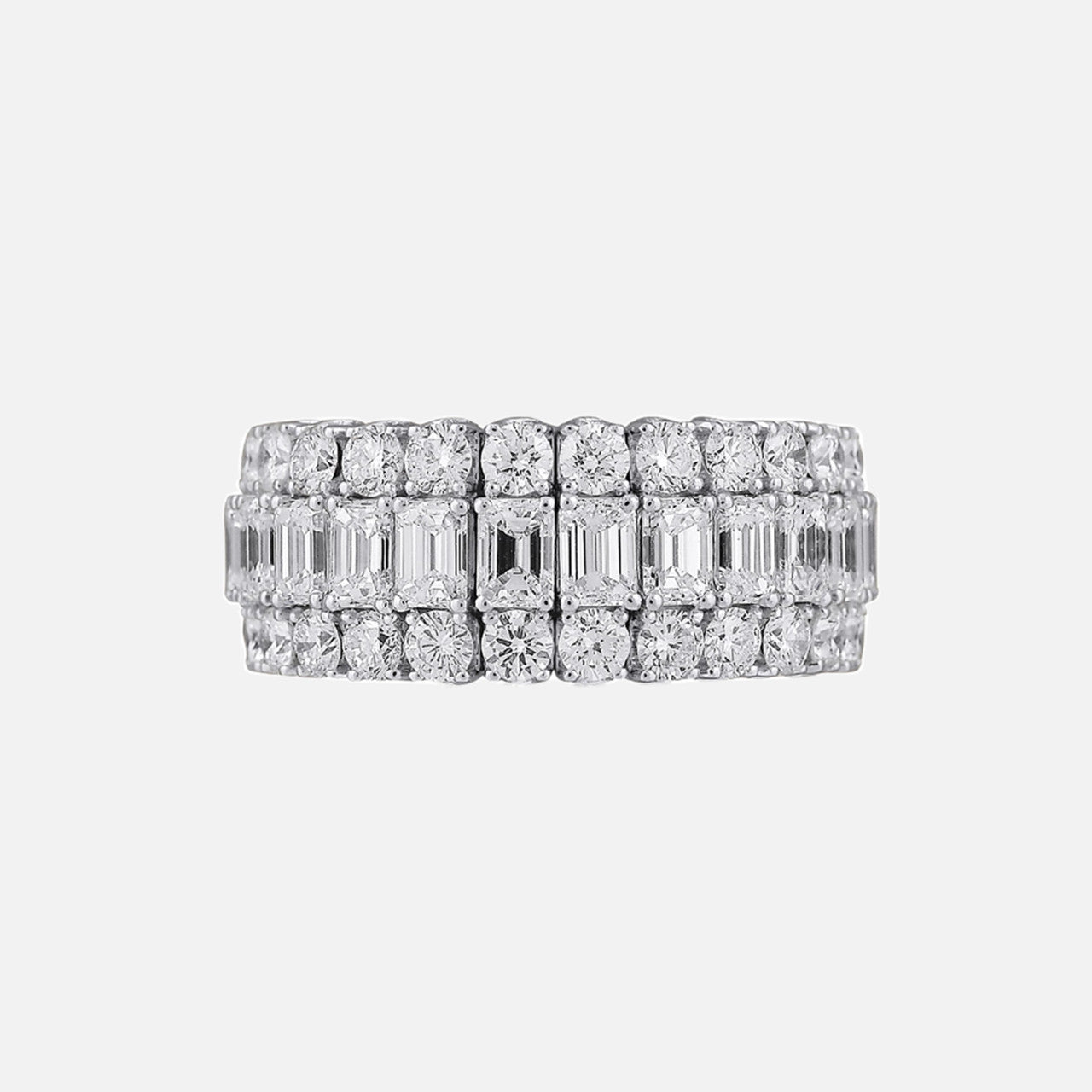 a diamond wedding band with three rows of diamonds. the top and bottom rows are round diamonds and the center row is emerald cut diamonds
