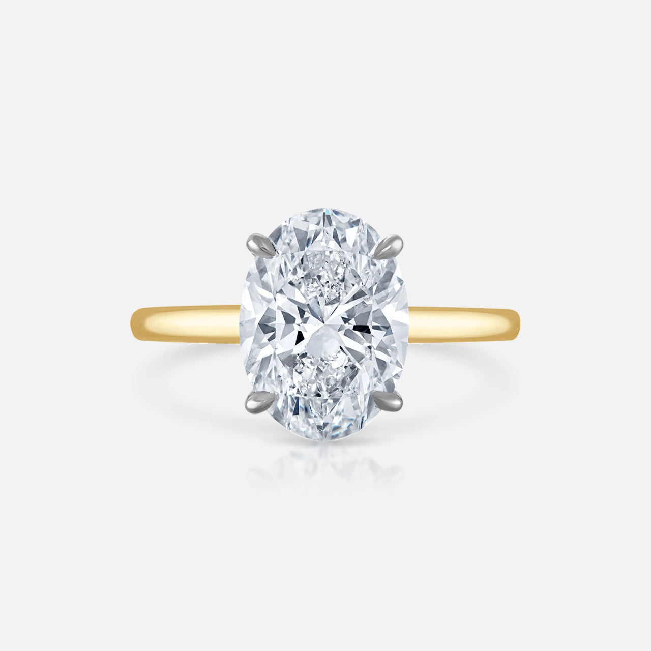 3.10 carat G/SI2 Oval Natural Diamond set in our yellow gold Signature Solitaire.