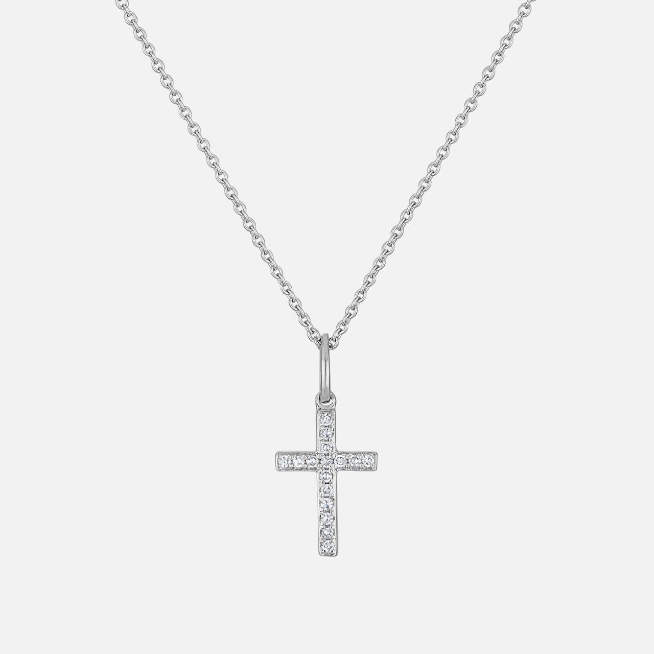 This mini diamond cross necklace features round natural diamonds.