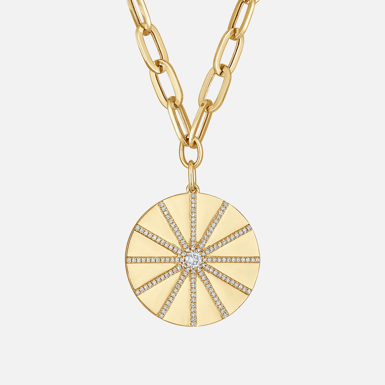 The Starburst Medallion Necklace, crafted in 14K solid gold, features round natural diamonds, symbolizing vitality, light, and strength.
