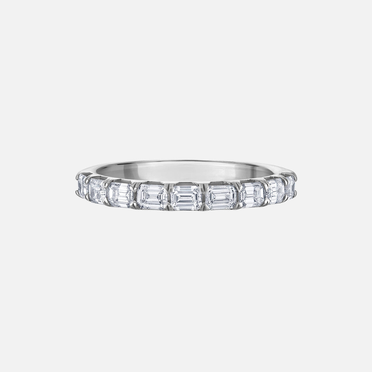 woman's half eternity wedding band with east to west, emerald cut diamonds