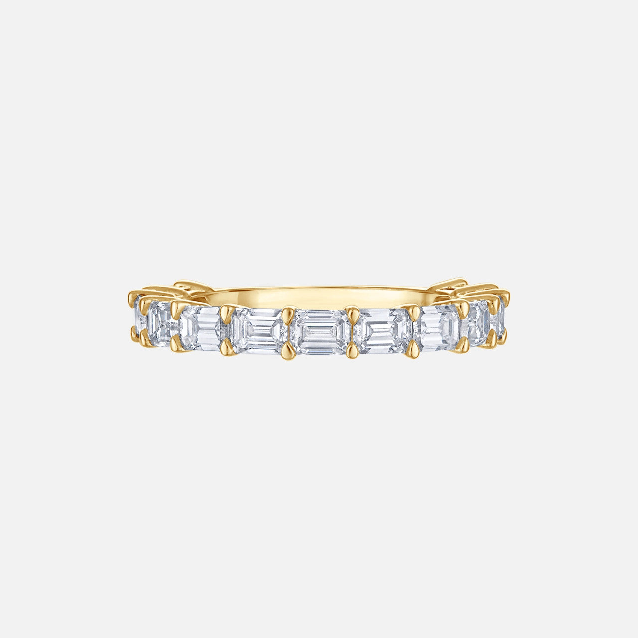 Refined emerald cut diamond 3/4 eternity band in yellow gold.