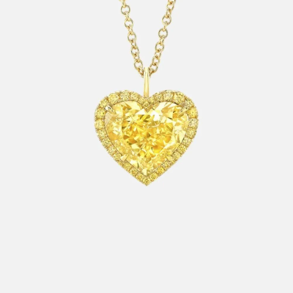 This gold necklace features a heart-shaped yellow diamond surrounded by a halo of 34 smaller yellow diamonds.