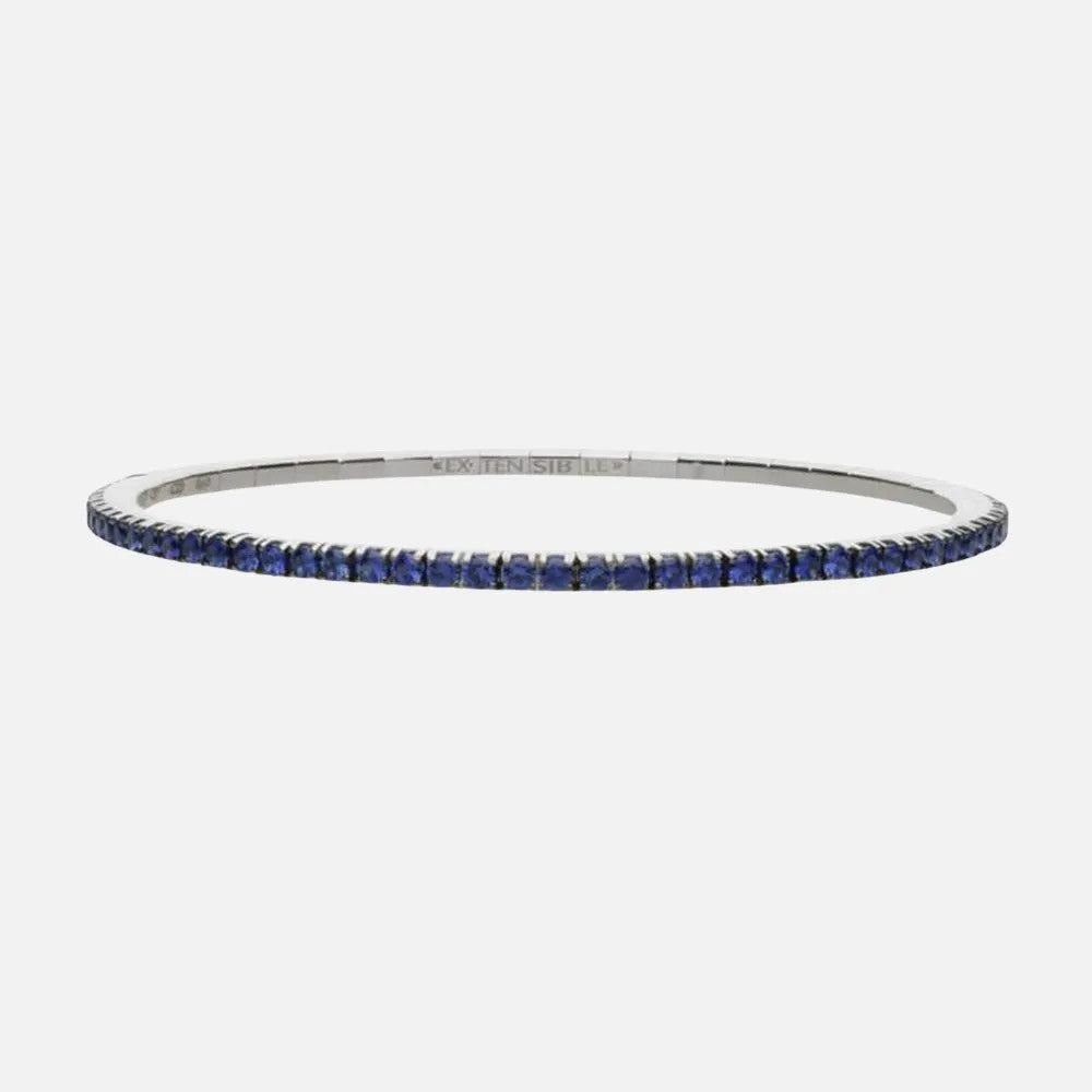 This white gold tennis stretch bracelet features a row of blue sapphires.