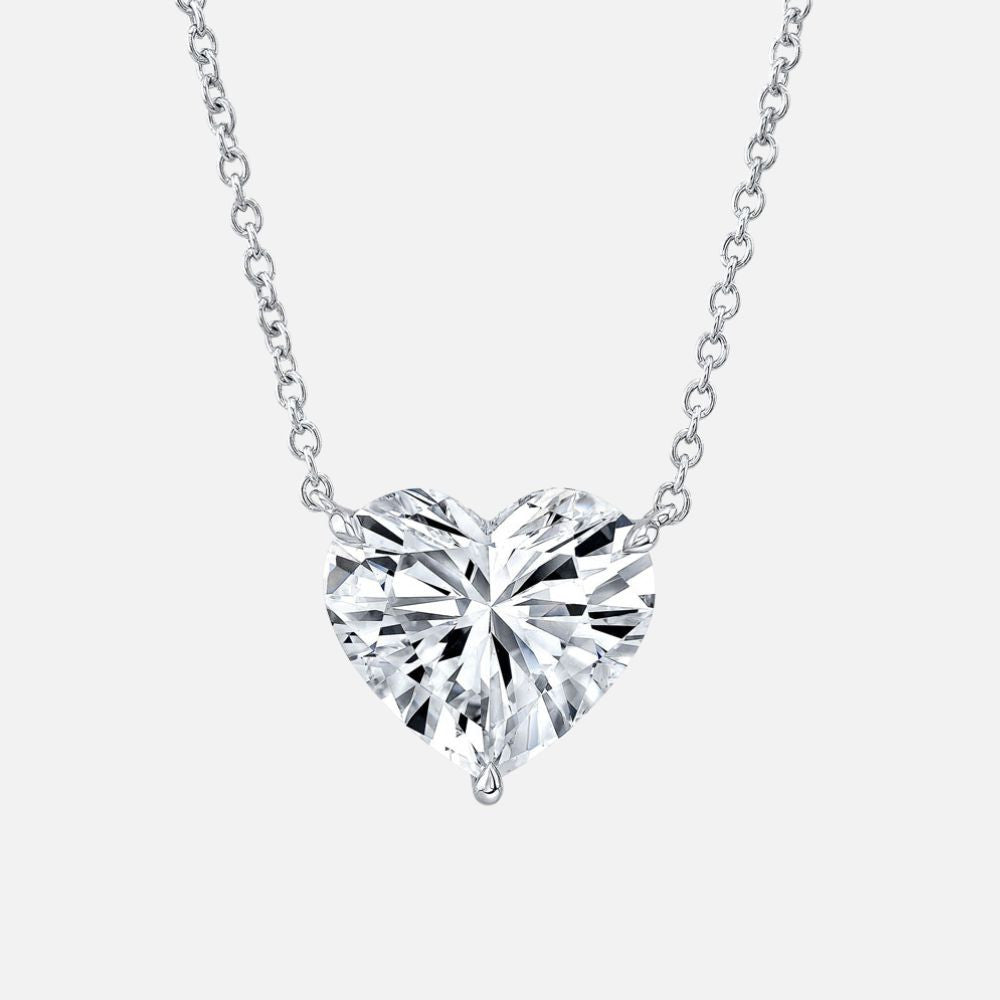 A heart-shaped diamond pendant is suspended from an 18-inch white gold chain.