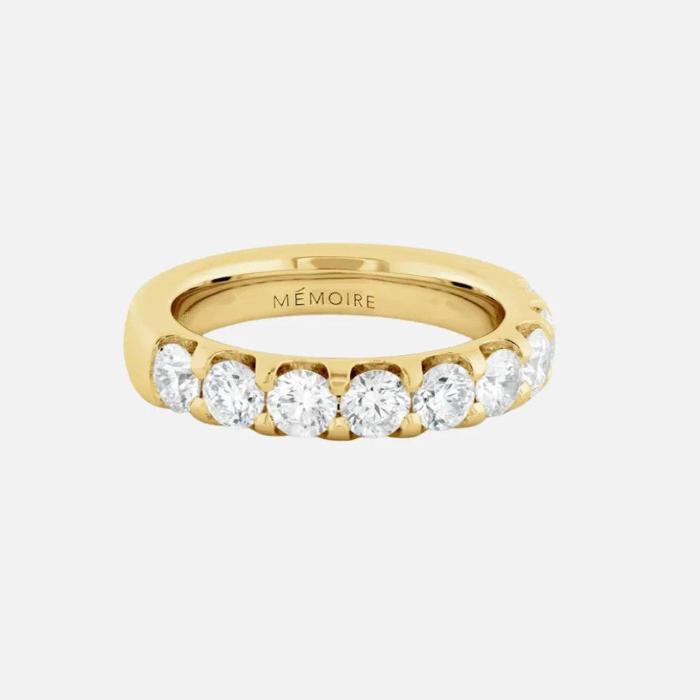 This yellow gold halfway band features a row of round diamonds set in secure prong settings.