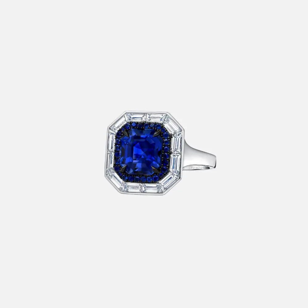 This platinum ring showcases a 4.33-carat emerald-cut blue sapphire surrounded by 12 baguette (1.69 carats) and 56 round diamonds (0.19 carats) and accented by 28 smaller blue sapphires.