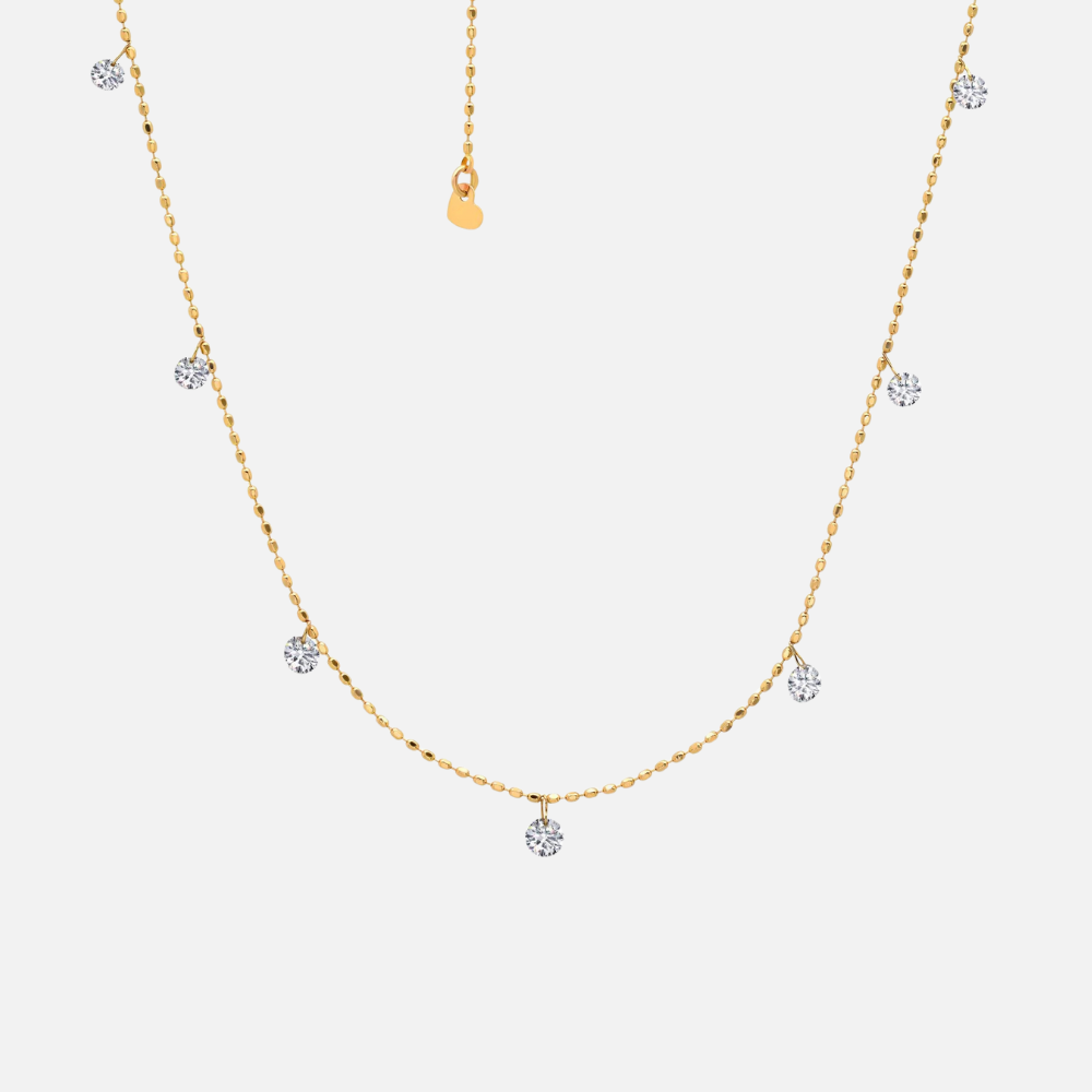 Seven round natural diamonds totaling 0.50 carats appear to float along this 18k yellow gold adjustable bolo chain.