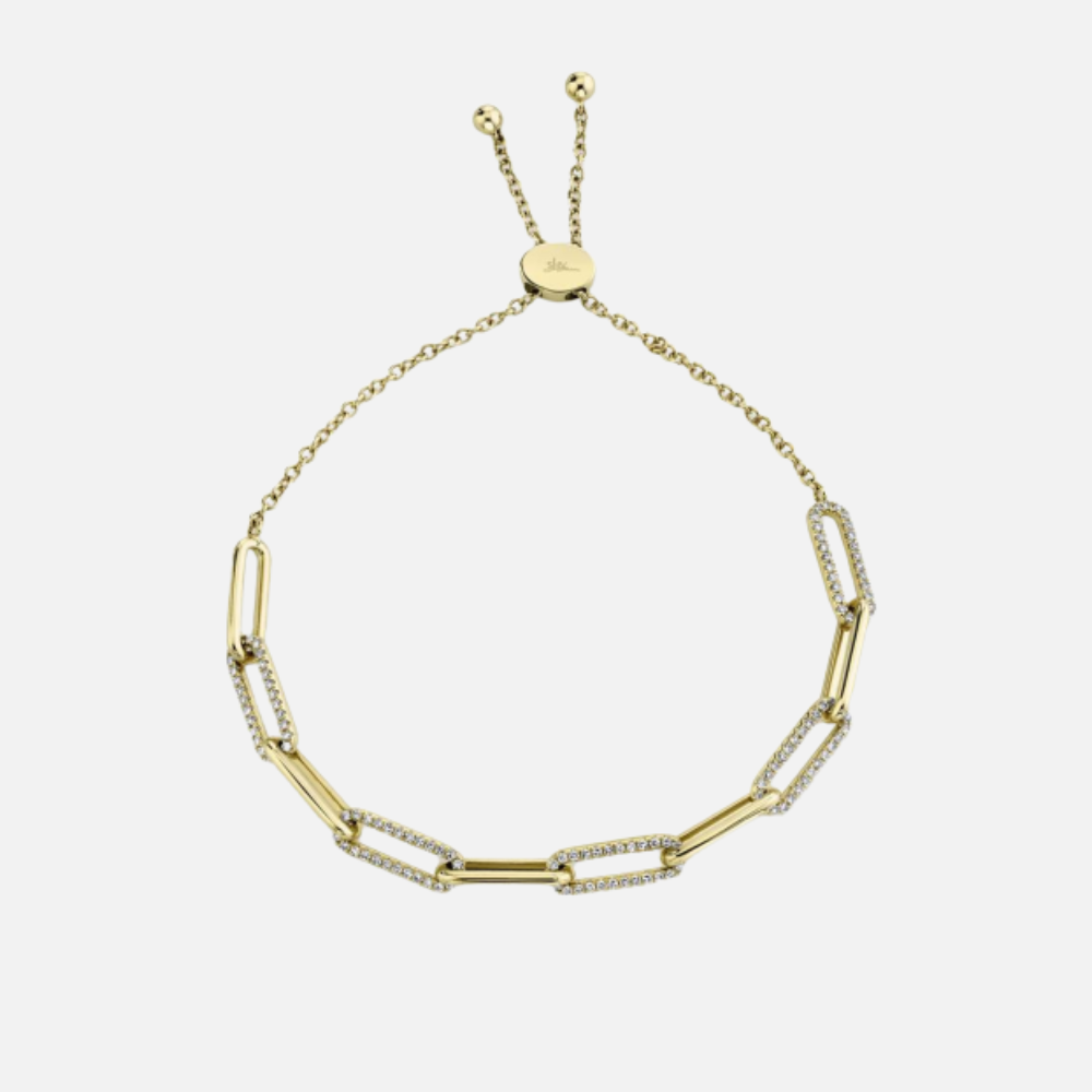 This Shy Creation bolo-style, 14k yellow gold bracelet has a paper-clip design featuring 0.40 carats of round diamonds on three of the clips.
