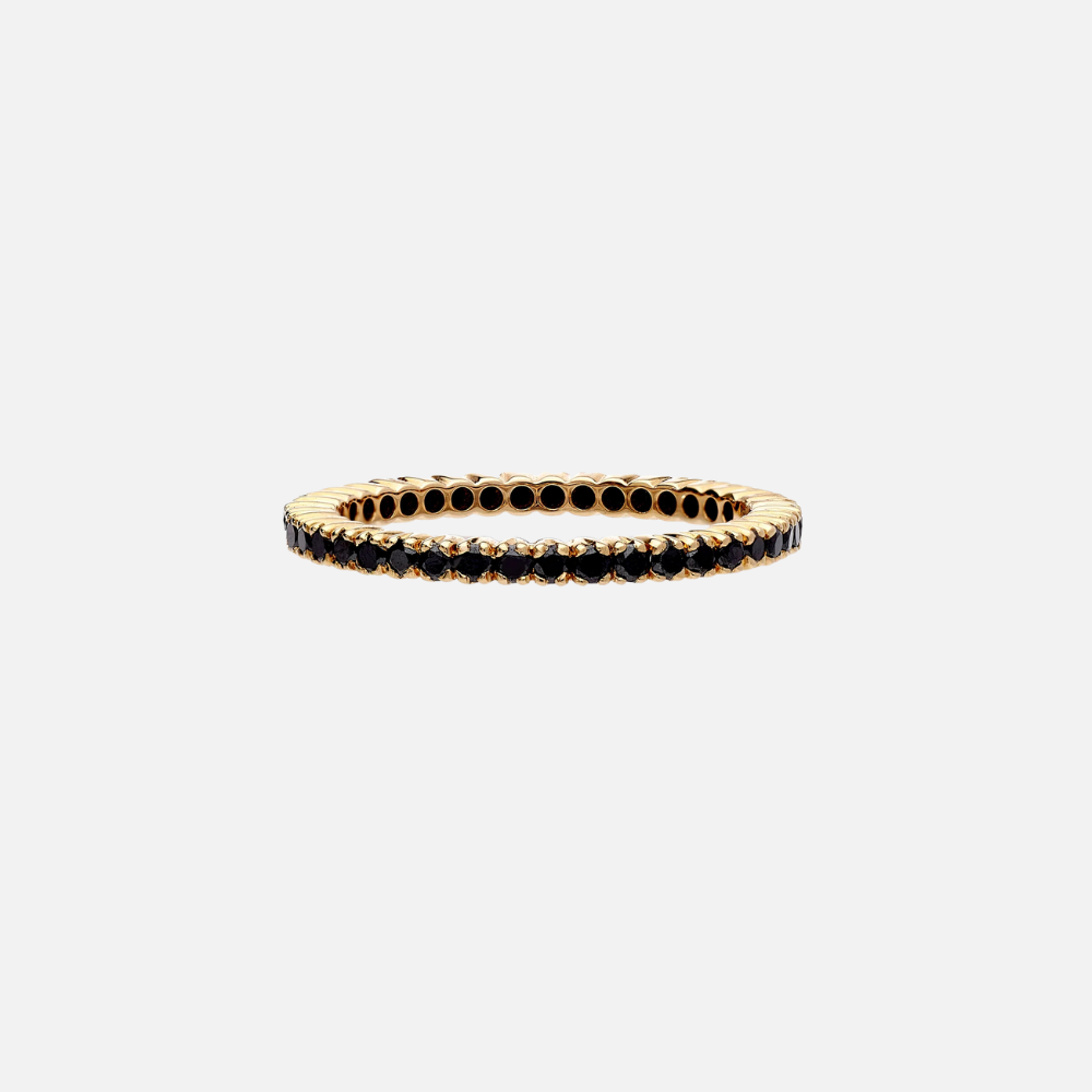 An 18k yellow gold eternity band set with 76 round diamonds in a prong setting.